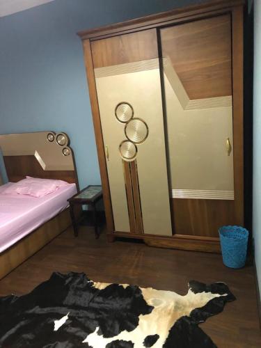 a bedroom with a bed and a black and white rug at cozy penthouse in New Cairo in Kharga