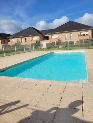 une piscine devant une maison dans l'établissement T3 duplex with garden, à Arpajon-sur-Cère