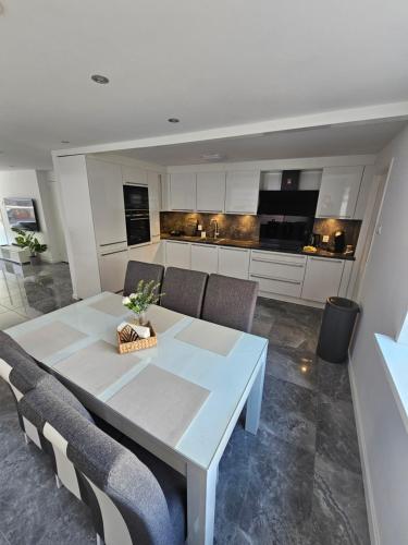 a kitchen and dining room with a table and chairs at Smile Home Wijk aan Zee 1 in Wijk aan Zee