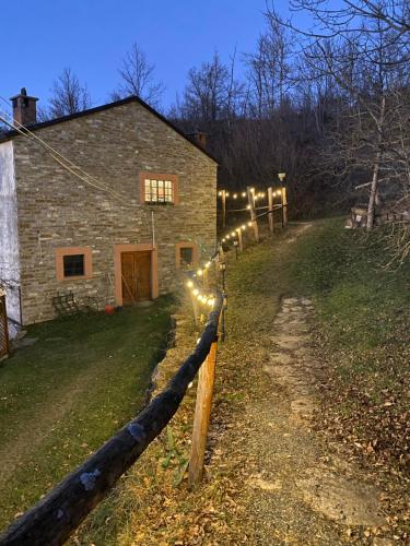 a barn with a fence with lights on it at La Lupa e l'Orso in Berceto
