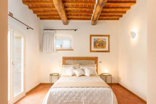 a bedroom with a bed with two tables at Suite Leonardo in San Gimignano