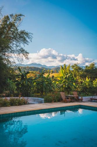 a swimming pool with a view of the mountains at The Hideaway Village in Ban Mae Hi