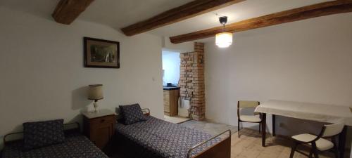 a living room with a couch and a bed and a table at Chata Wilczka in Miedzygorze