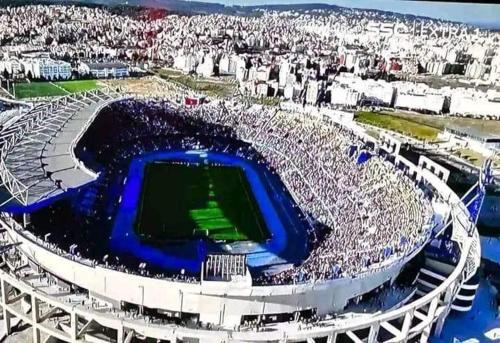 a stadium full of people watching a soccer game at Appartement Familial en Face le Stade Ibn Batouta Tanger in Tangier