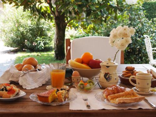 a table filled with breakfast foods and orange juice at BB Da La Mi Ma, Gradara in Gradara