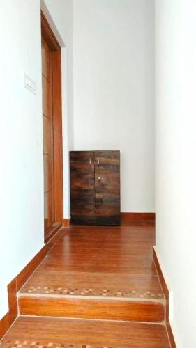 a room with a dresser in the corner of a room at Samuels Comfort Homes in Bengaluru