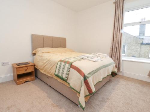 a bedroom with a bed and a window at 163 Manchester Road in Accrington