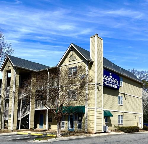 a building with a sign on the side of it at Live In Lodge Marietta in Marietta