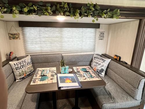 a small living room with a table and a couch at Sleepyheadz Campers and Tents LLC in Bloomington