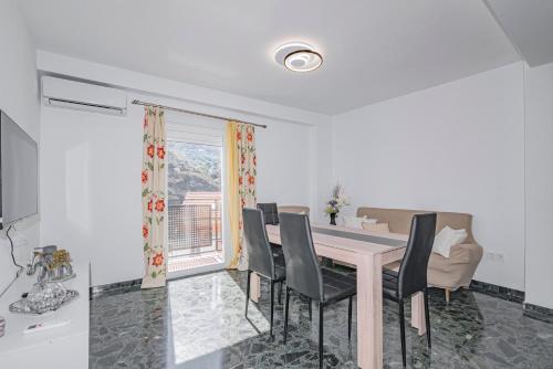a dining room with a table and chairs and a window at Casa de la Abuela in Quéntar