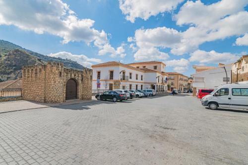 a town with cars parked in a parking lot at Casa de la Abuela in Quéntar