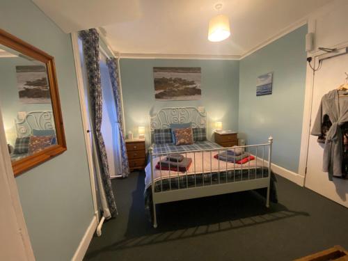 a bedroom with a bed in a room with a window at Forse of Nature in Latheron
