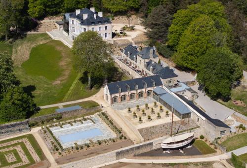 an aerial view of a large house with a swimming pool at Domaine de Locguénolé & Spa - Relais & Chateaux in Kervignac