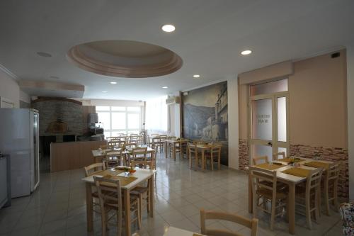 a restaurant with tables and chairs in a room at Hotel Riggioni in Pozzilli