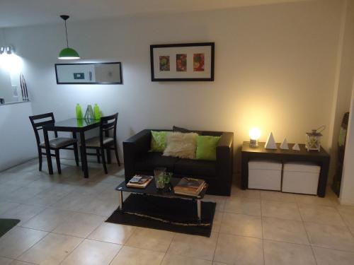 a living room with a couch and a table at Departamento Calle 46 in La Plata