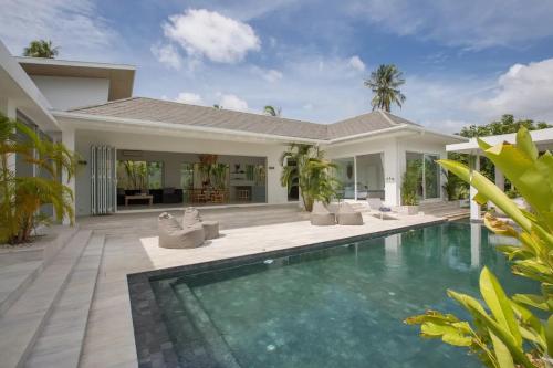a swimming pool in front of a villa at Enchanting 4Br Villa Private Pool & Breakfast incl in Mae Nam