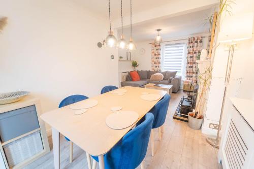 a kitchen and living room with a table and chairs at Kilmallie House in Caol