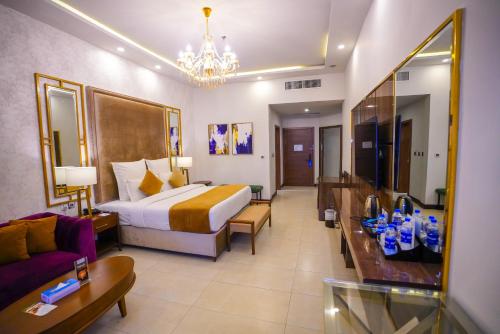 a hotel room with a bed and a couch at IFQ Hotel & Resort Islamabad in Islamabad