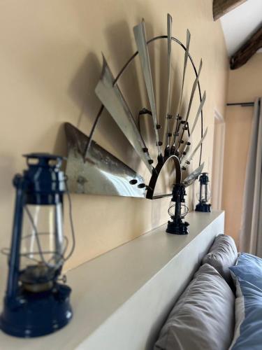 a shelf with two lights and a fan on it at The Windmill Country Retreat in Hazyview