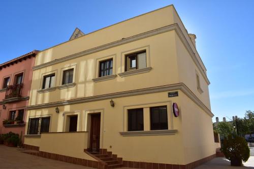 a large white building with windows on a street at Charming duplex in Hacienda del Álamo in Fuente Alamo