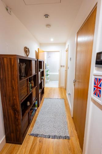 a hallway with a book shelf and a door at Lux Room to London Eye in London