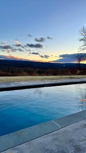 a pool of water with a sunset in the background at Inness in Accord