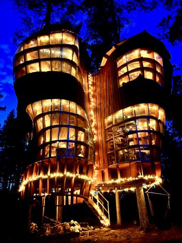 a building with lights on it at night at Haven Islands incredible treehouse on private island in Torrflonäs