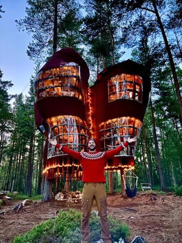 a man standing in front of a tree house at Haven Islands incredible treehouse on private island in Torrflonäs