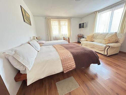 a bedroom with a large bed and a couch at Cabana Sweetlife in Rimetea