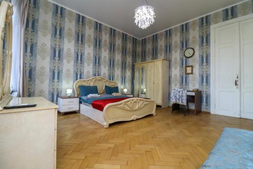 a bedroom with a bed with blue and white wallpaper at Leon Rooms in Tbilisi City