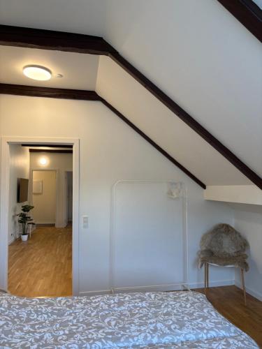 a room with a bed and a white wall at Central Living Billund - By Viktorija #1 VIEW in Billund
