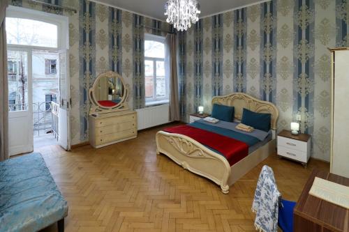 a bedroom with a bed and a mirror at Leon Rooms in Tbilisi City