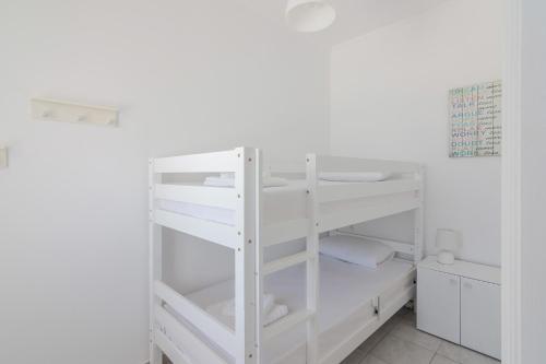 a white bunk bed in a white room at Stavros Oak Tree House in Vasilópoulon