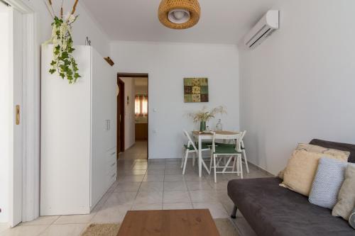 a living room with a couch and a table at Stavros Oak Tree House in Vasilópoulon