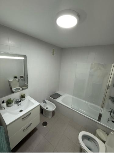 a bathroom with a sink and a toilet and a shower at Mini Estudio LOVELY SEVILLA con baño compartido in Camas