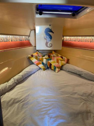 a large bed in a small room at Charming Sailboat in Lisbon