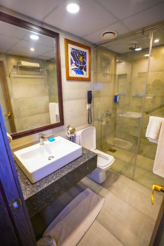 a bathroom with a sink and a shower at IFQ Hotel & Resort Islamabad in Islamabad