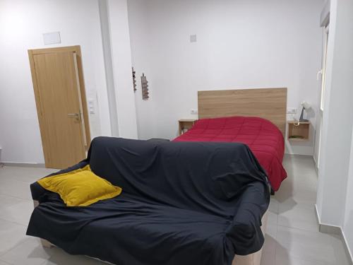 a bed and a couch in a room at Finisterrae Centro in Finisterre