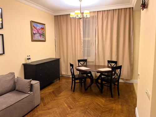 a living room with a table and chairs and a couch at Апарт-отель "ГАЛАГОВЪ" in Uzhhorod