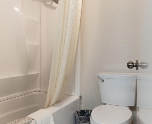 a white bathroom with a toilet and a shower at Water Front Inn in Port Townsend