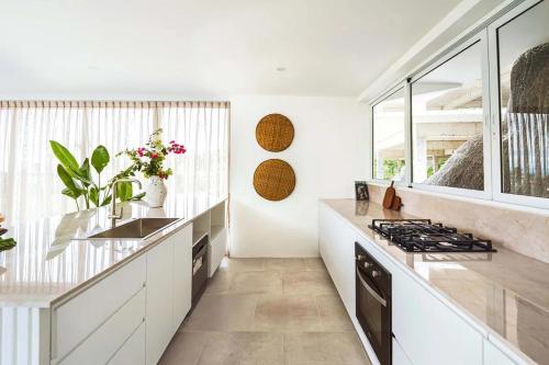 a kitchen with white counters and a stove top oven at Villa Umi 4 Br Private Pool & Sea View in Ban Lamai