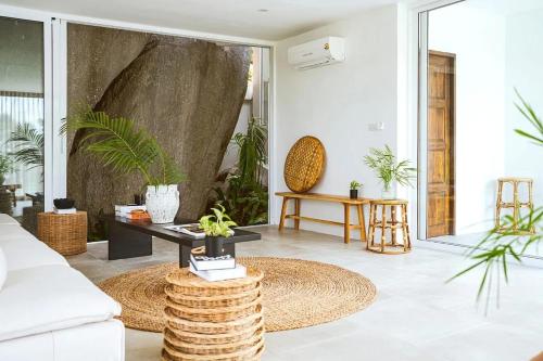 a living room with a couch and a table at Villa Umi 4 Br Private Pool & Sea View in Ban Lamai