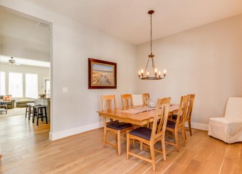 a dining room and living room with a table and chairs at 408B The Lynnhaven House Spacious 4 BR Townhouse Walking Distance to the Beach and Boardwalk in Virginia Beach