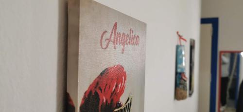 a painting of a red bird on a wall at Casa Giusi in Sferracavallo