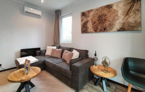 a living room with a couch and two tables at Casa Sallandia met Outdoor Wellness! in Haarle
