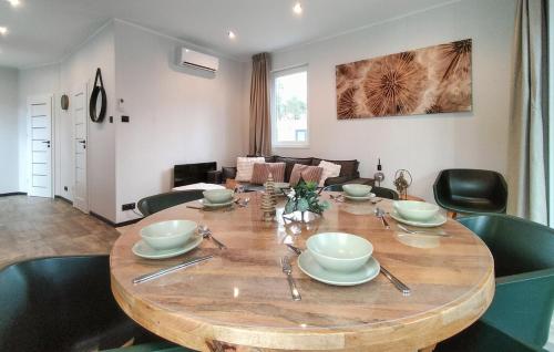 a dining room table with bowls and plates on it at Casa Sallandia met Outdoor Wellness! in Haarle