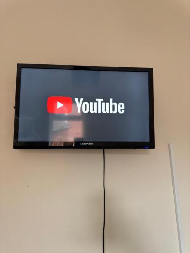 a flat screen tv with the youtube logo on it at House in Lisburn road in Belfast
