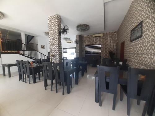 a dining room with blue tables and chairs at Sanford Hotel & Restaurant Colombo in Wattala