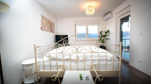 a white bed in a room with a window at Trogir Padre Dante FREE PARKING and STARLINK High speed internet in Trogir