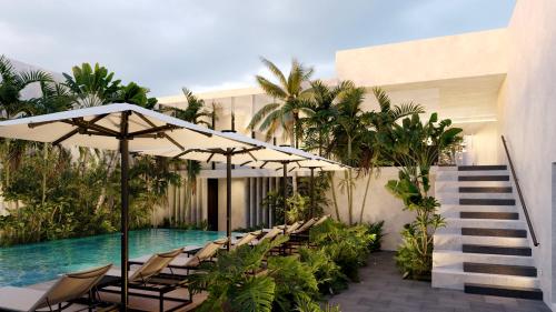 a pool with chairs and umbrellas next to a building at Pueblo Bonito Vantage Centro Histórico Mazatlán in Mazatlán